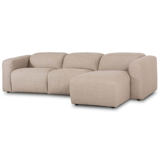 Sofa narozna o zaokraglonej formie z prostym detalem w odcieniu bezu